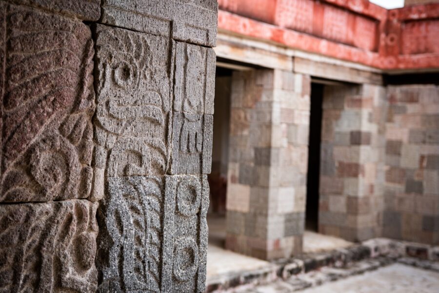 Closeup of detailed engravings on a stone pillar in the Palace of Quetzalpapalotl in Mexico