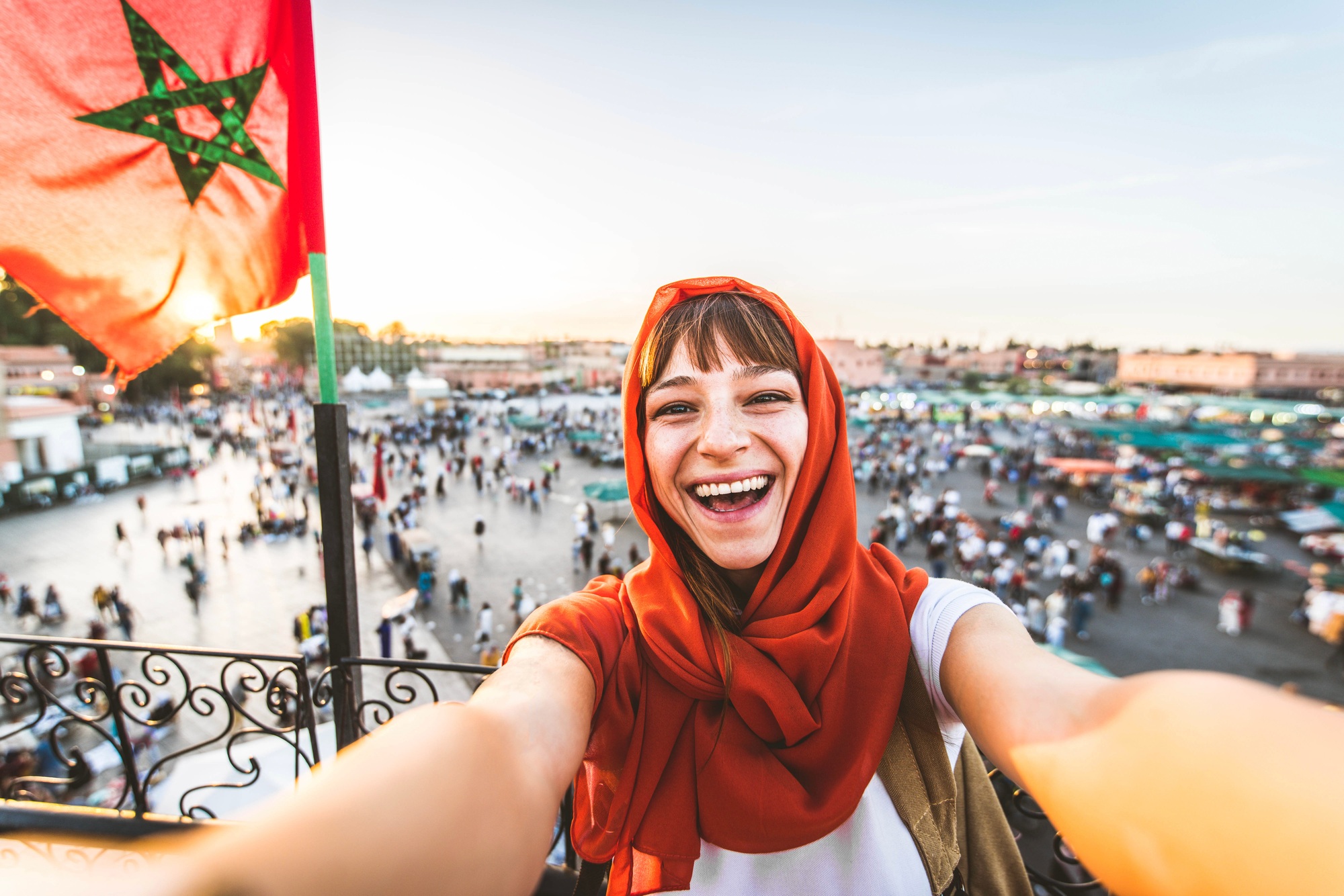Happy tourist visiting Jamaa el-Fna market, Morocco